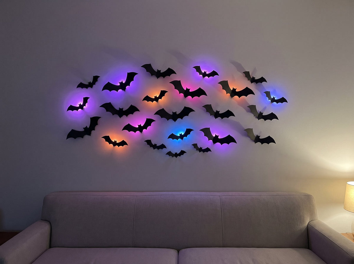24 HauntGlow bats above a sofa, each lit bat glowing its own colour