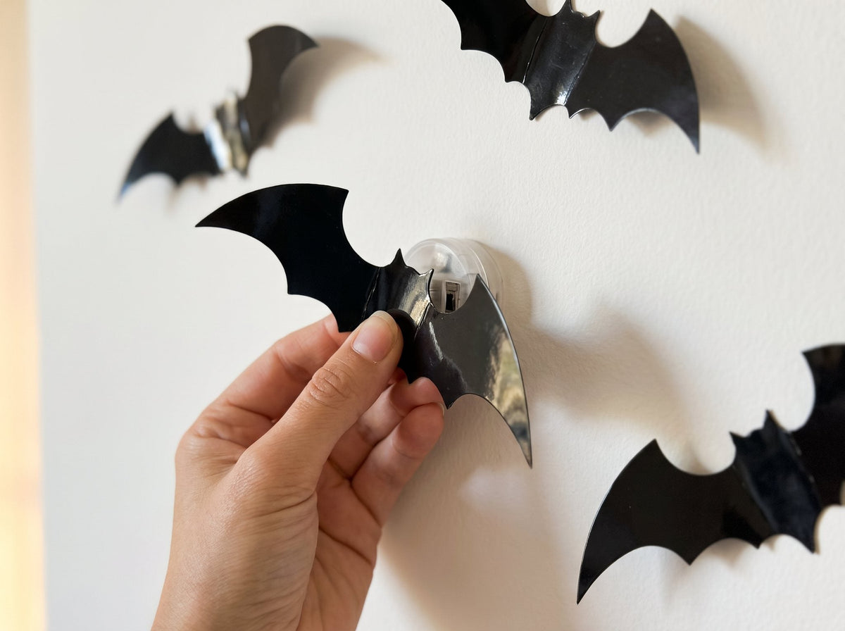 Clipping a black bat onto the LED light on the wall