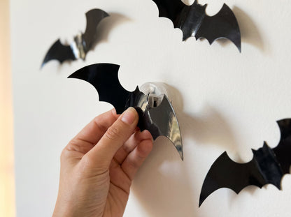 Clipping a black bat onto the LED light on the wall