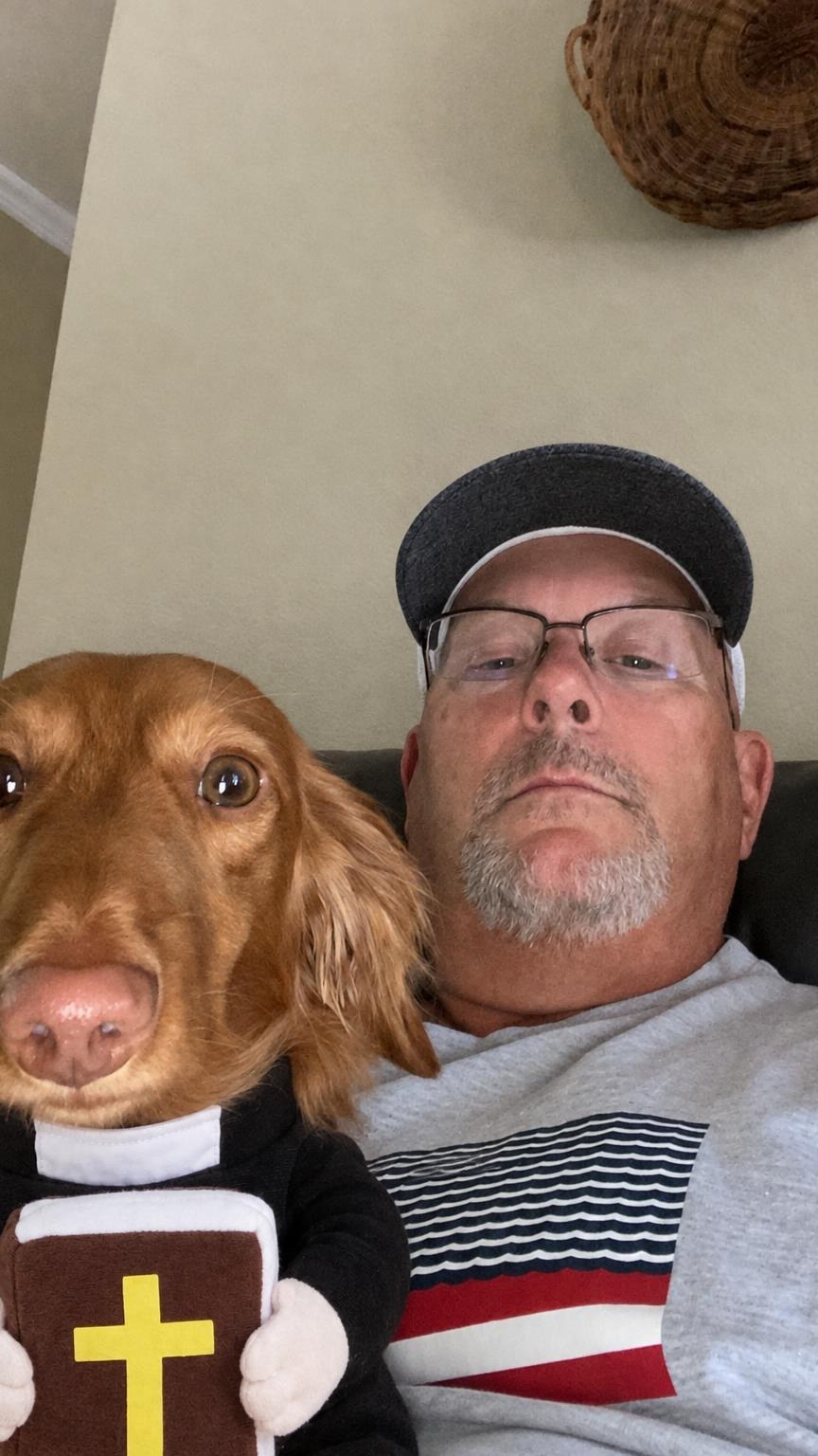 Customer with his dachshund in the Holy Priest costume