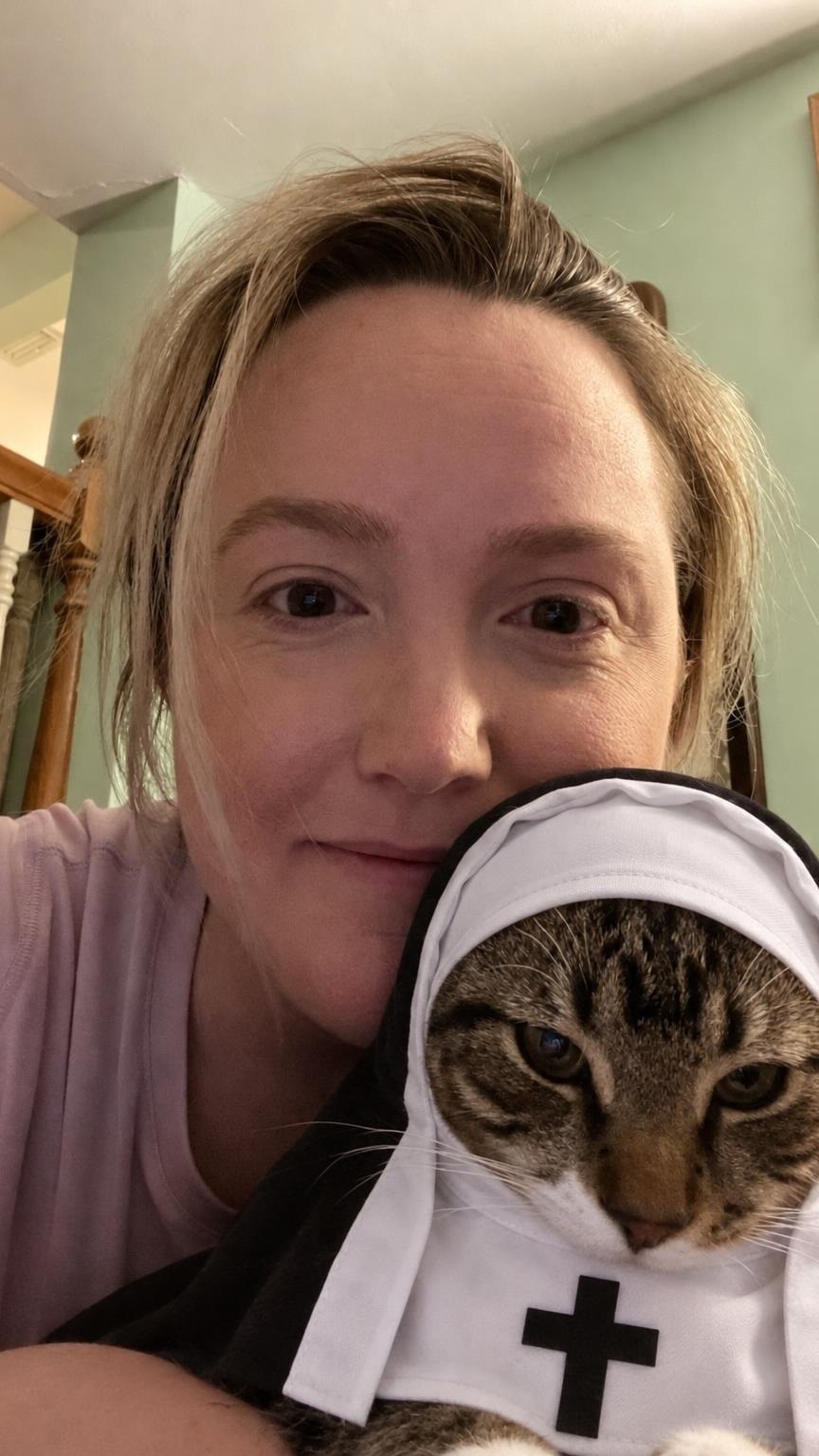 Customer with her tabby cat in the Holy Nun costume
